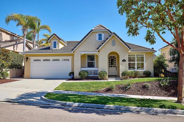 an aerial view of residential houses with outdoor space and ocean