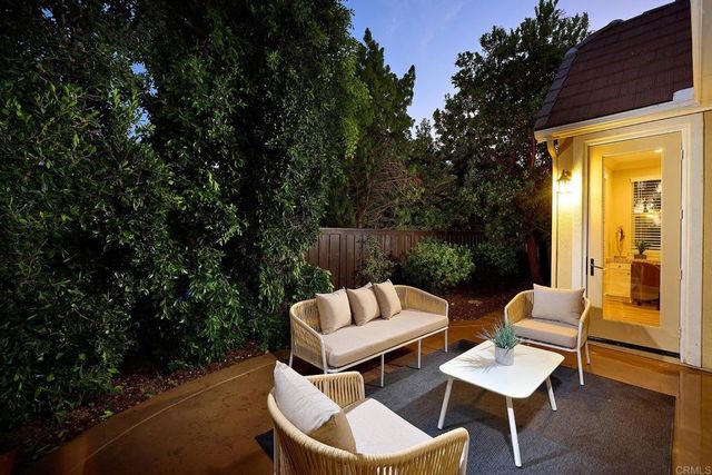 a view of a chair and tables in the back yard of the house