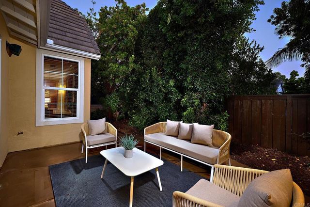 a outdoor space with patio couches and a potted plant on a table