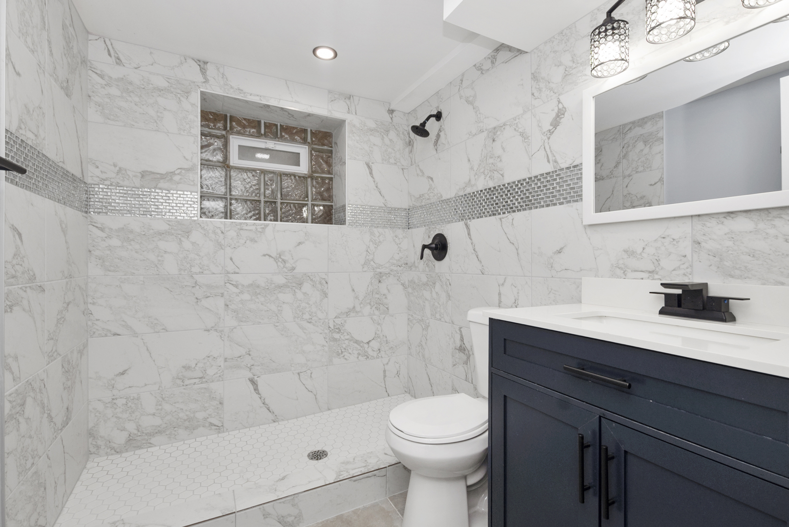 643 East 89th Street Chicago, IL 60619 - Photo 18 of 28 a bathroom with a sink a toilet and shower