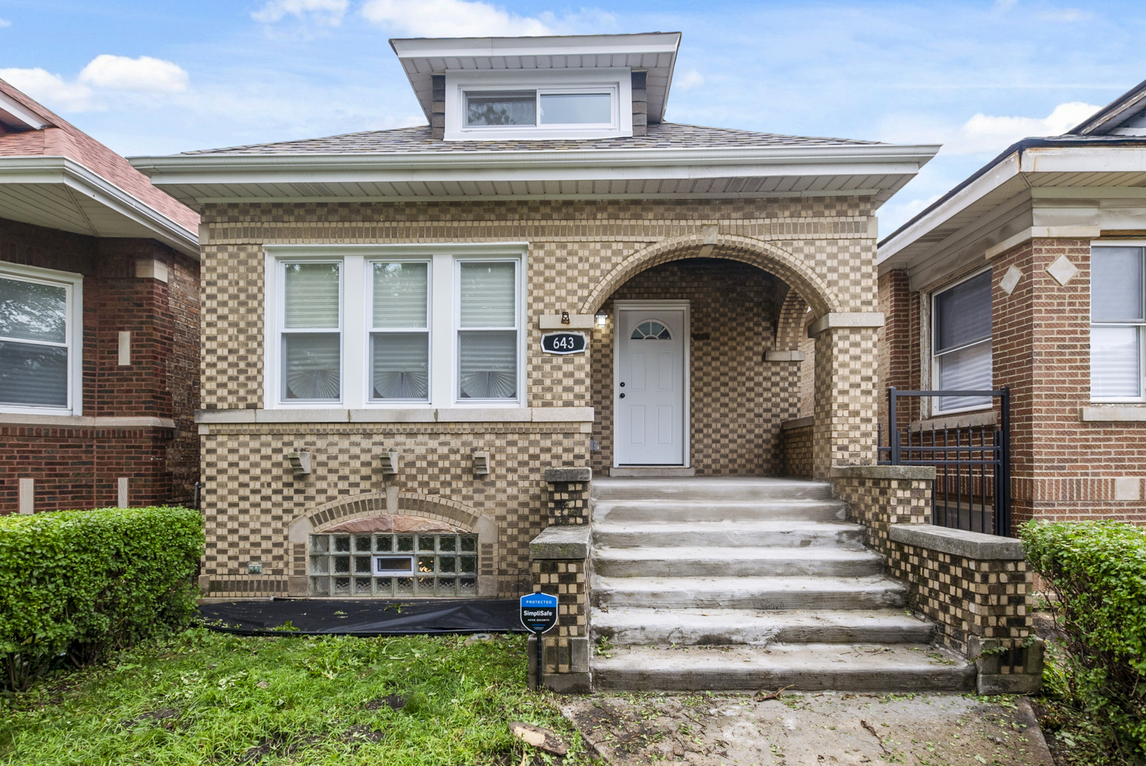 643 East 89th Street Chicago, IL 60619 - Photo 2 of 28 a front view of a house with a garden
