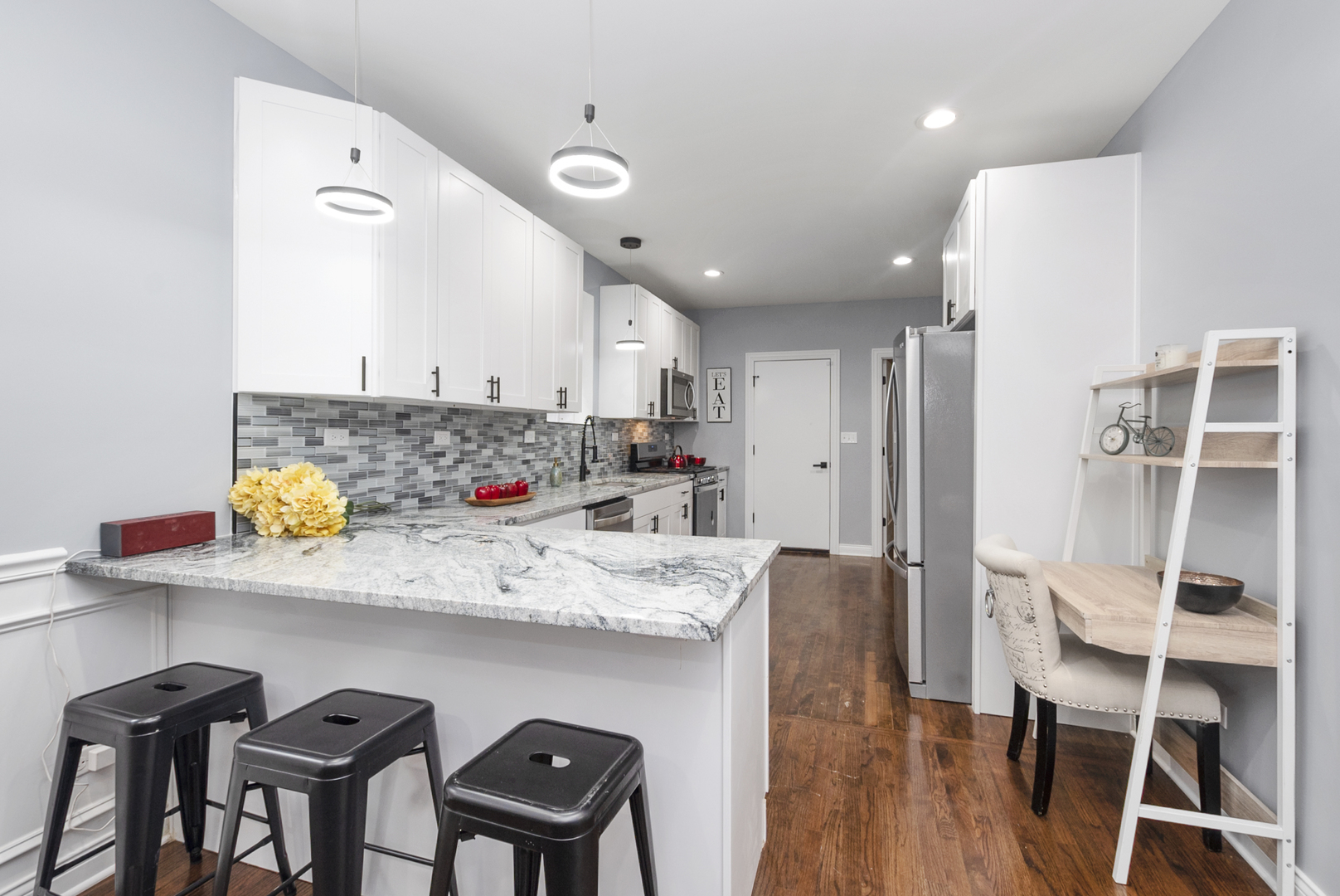 643 East 89th Street Chicago, IL 60619 - Photo 7 of 28 a kitchen with stainless steel appliances granite countertop a table chairs sink and cabinets