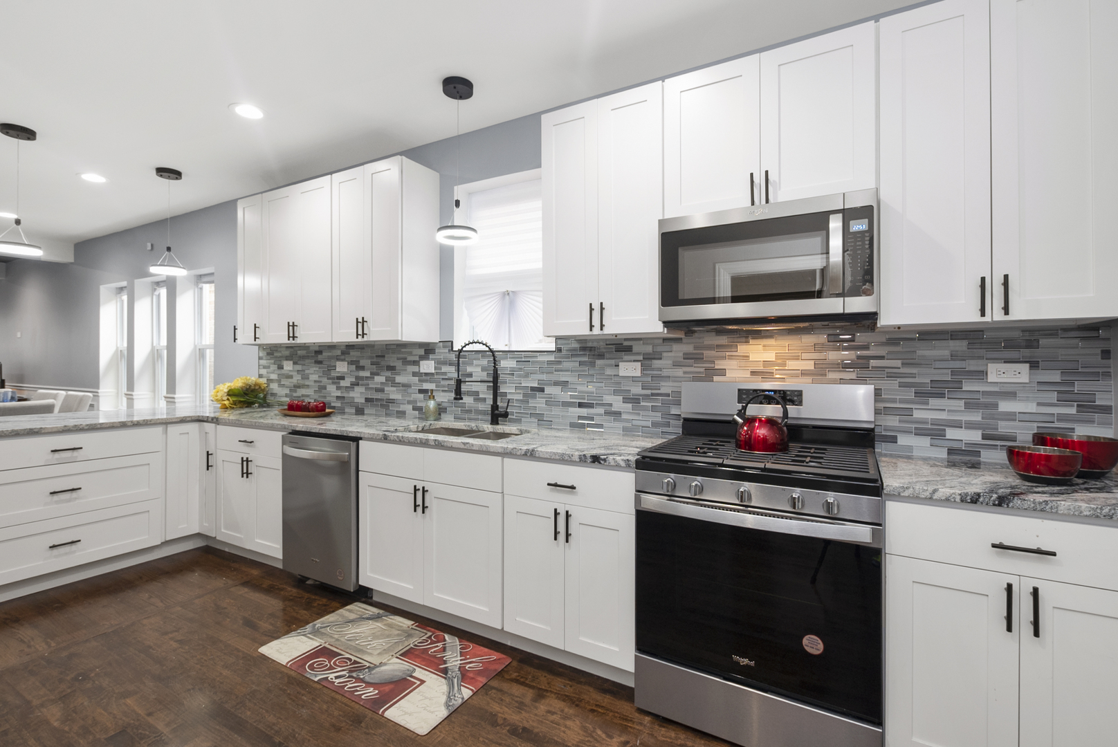 643 East 89th Street Chicago, IL 60619 - Photo 10 of 28 a kitchen with stainless steel appliances a stove microwave and cabinets