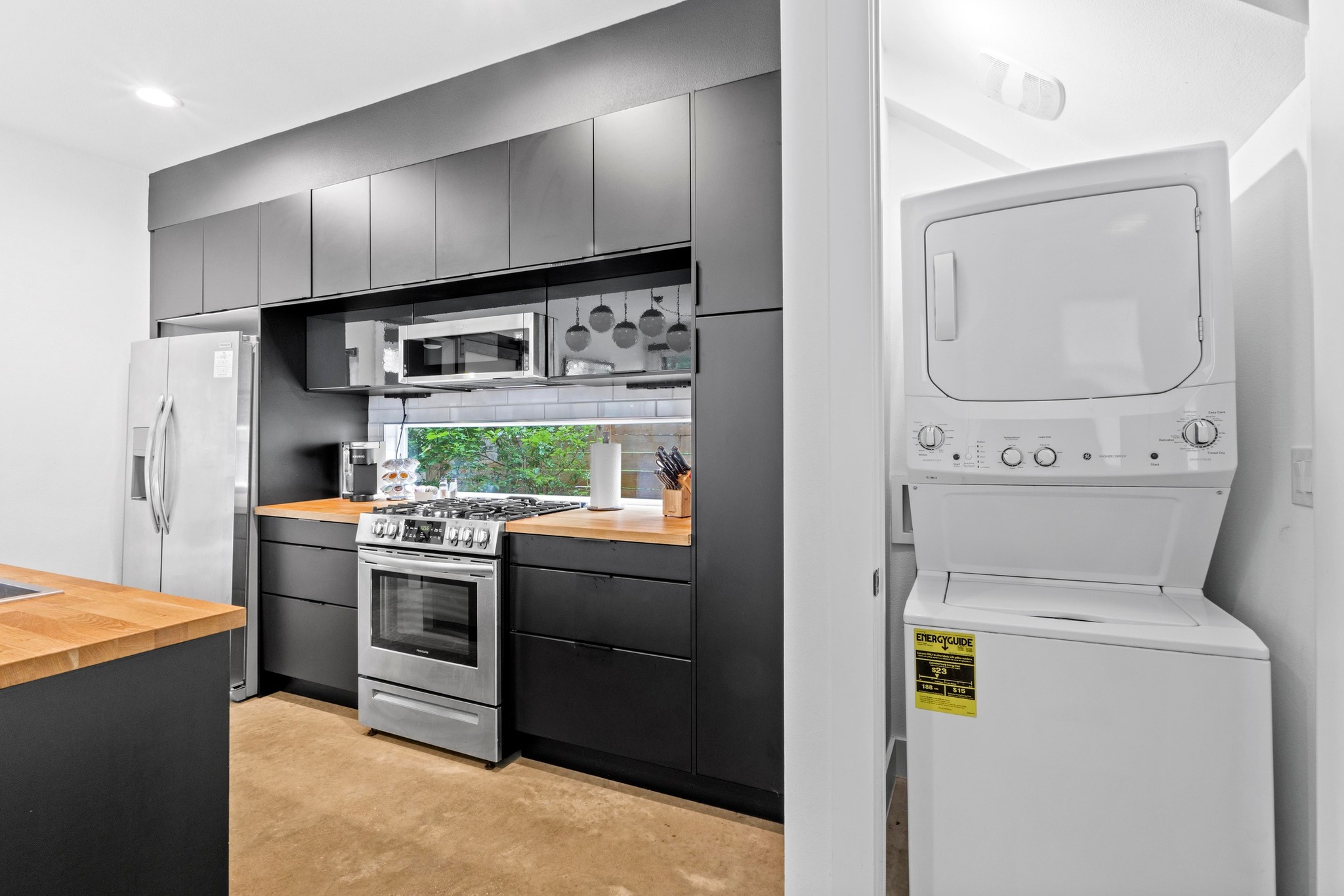 1706 Perez Street, Unit 2 Austin, TX 78721 - Photo 23 of 29 Modern kitchen with streamlined cabinetry and a convenient laundry nook.