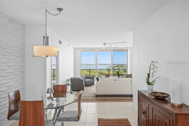a spacious bedroom with a bed and glass window