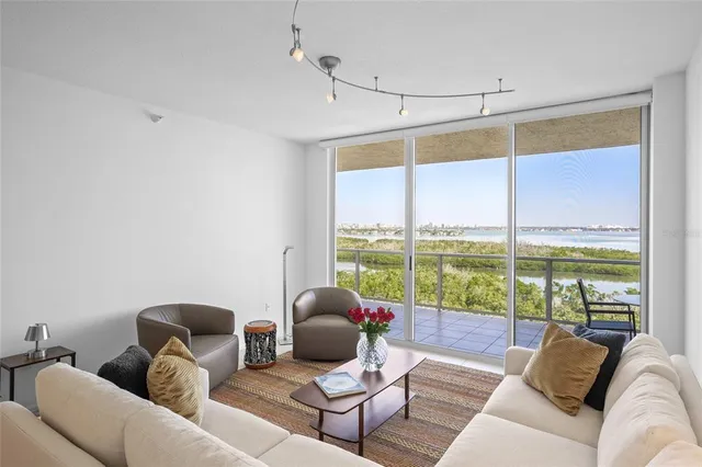 a kitchen with a refrigerator and white cabinets