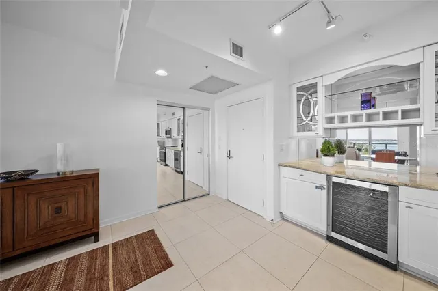 a kitchen with granite countertop white cabinets and sink