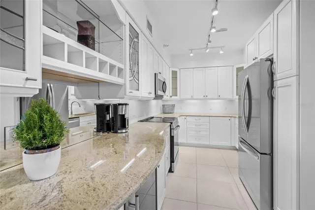 a living room with furniture a bed and a chandelier