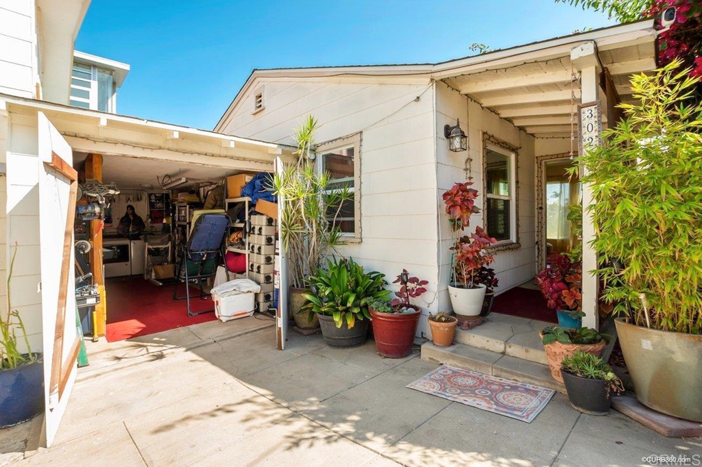 3023-3027 Olive Street San Diego, CA 92104 - Photo 20 of 41 Private 1 car garage with room for parking 1 small car in front of the garage.