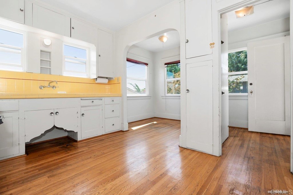 3023-3027 Olive Street San Diego, CA 92104 - Photo 29 of 41 Bright, vintage kitchen with breakfast nook and utility area leading to side yard