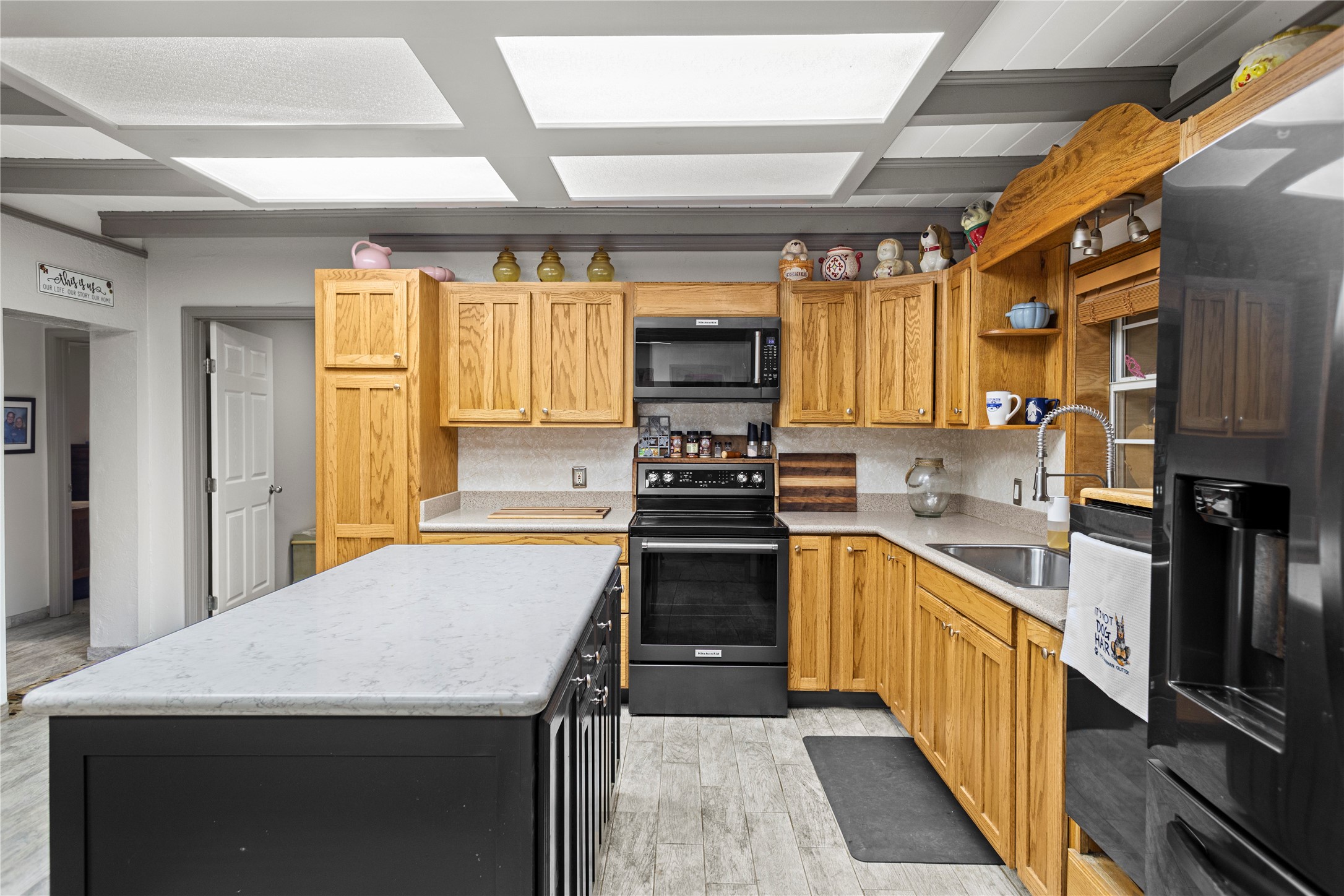 879 Interstate 45 Huntsville, TX 77340 - Photo 13 of 47 a kitchen with stainless steel appliances a stove sink microwave and cabinets