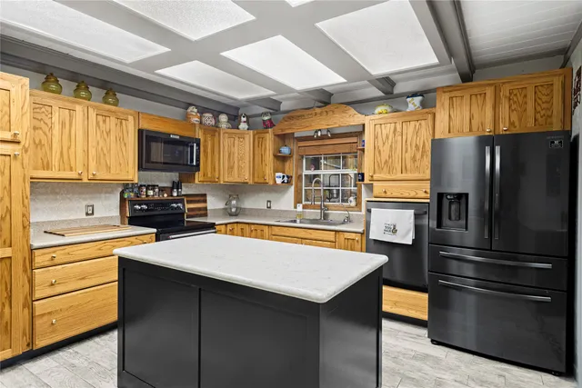 a kitchen with stainless steel appliances a refrigerator sink and microwave