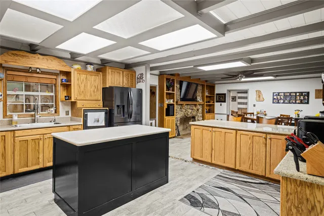 a kitchen with stainless steel appliances kitchen island granite countertop a sink and cabinets