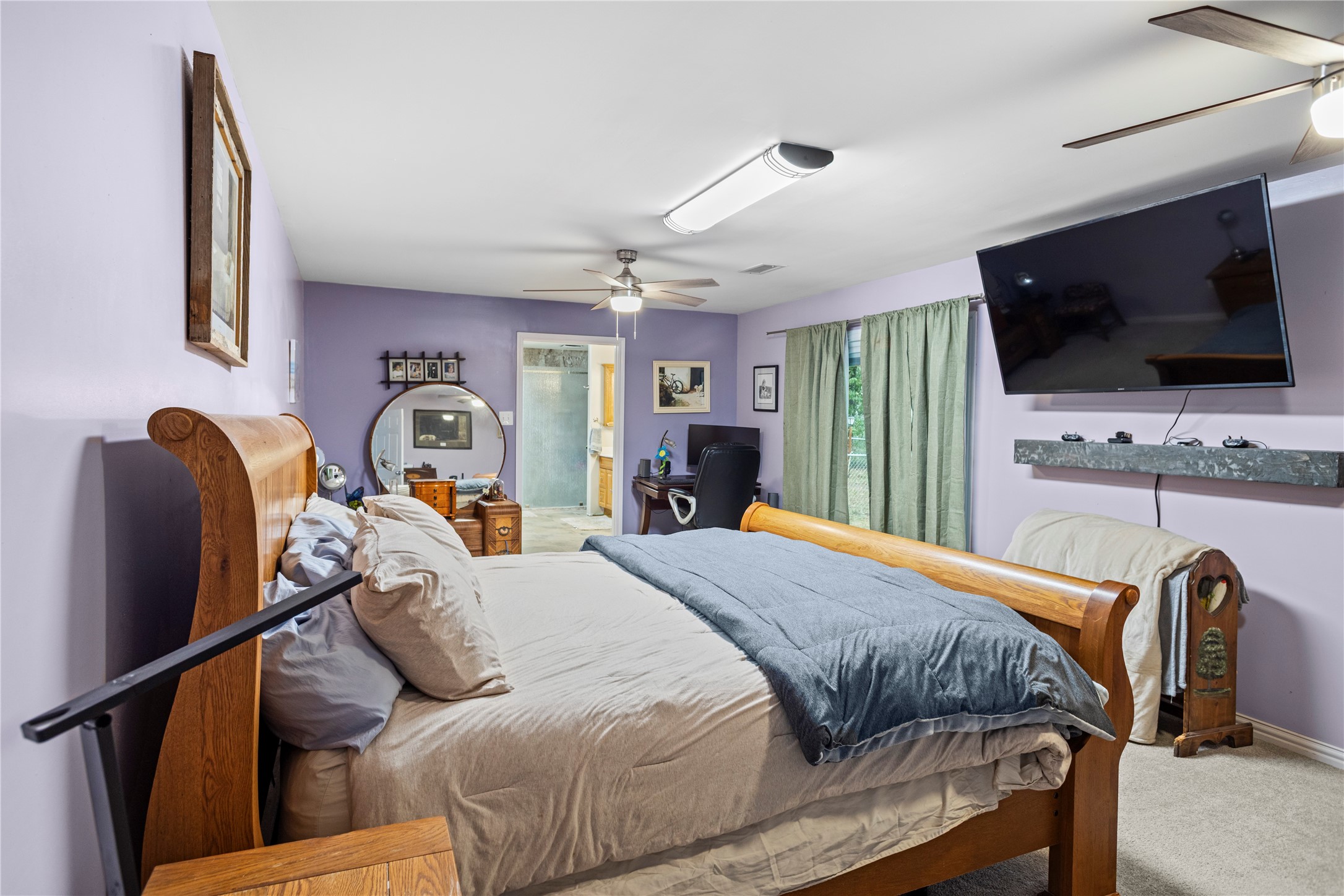 879 Interstate 45 Huntsville, TX 77340 - Photo 16 of 47 a bedroom with a bed and a flat screen tv