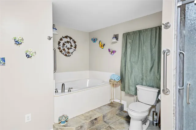 a bathroom with a toilet a sink and bathtub