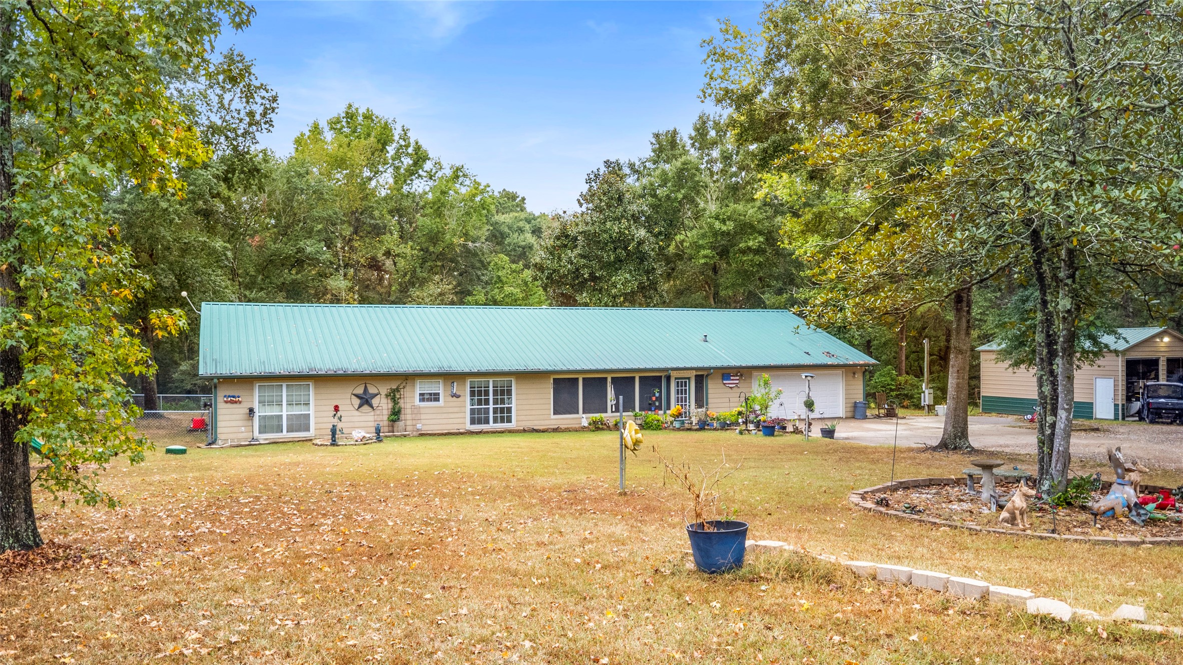 879 Interstate 45 Huntsville, TX 77340 - Photo 2 of 47 a front view of a house with swimming pool and patio