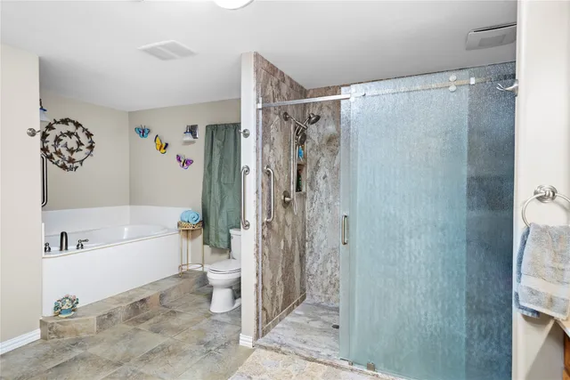 a bathroom with a bathtub and a shower