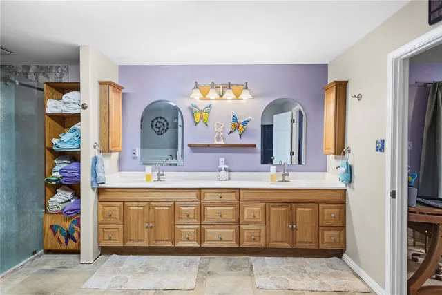 a bathroom with a double vanity sink and a mirror