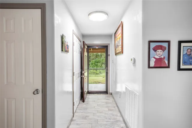 a view of a hallway to rooms