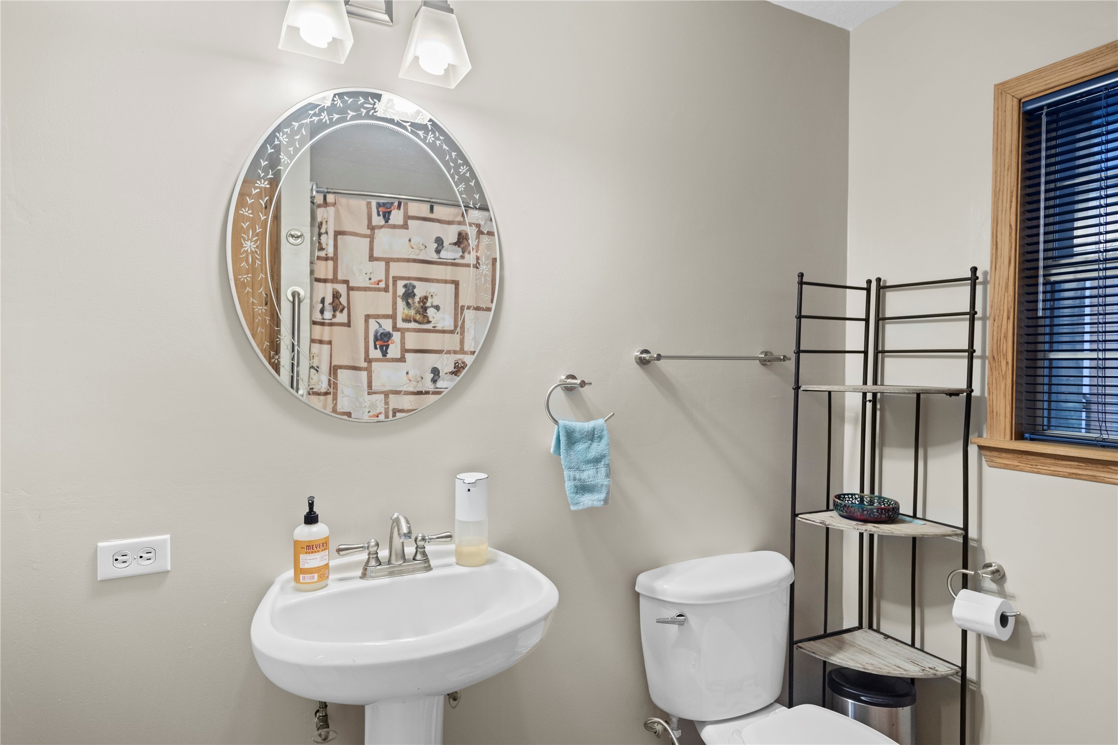 879 Interstate 45 Huntsville, TX 77340 - Photo 28 of 48 a bathroom with a toilet sink and mirror