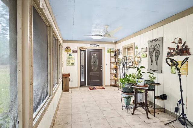 a view of a hallway with furniture and a potted plant