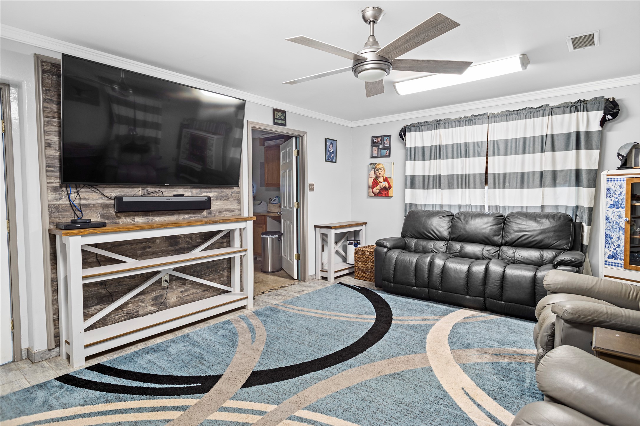 879 Interstate 45 Huntsville, TX 77340 - Photo 7 of 47 a living room with furniture and a flat screen tv