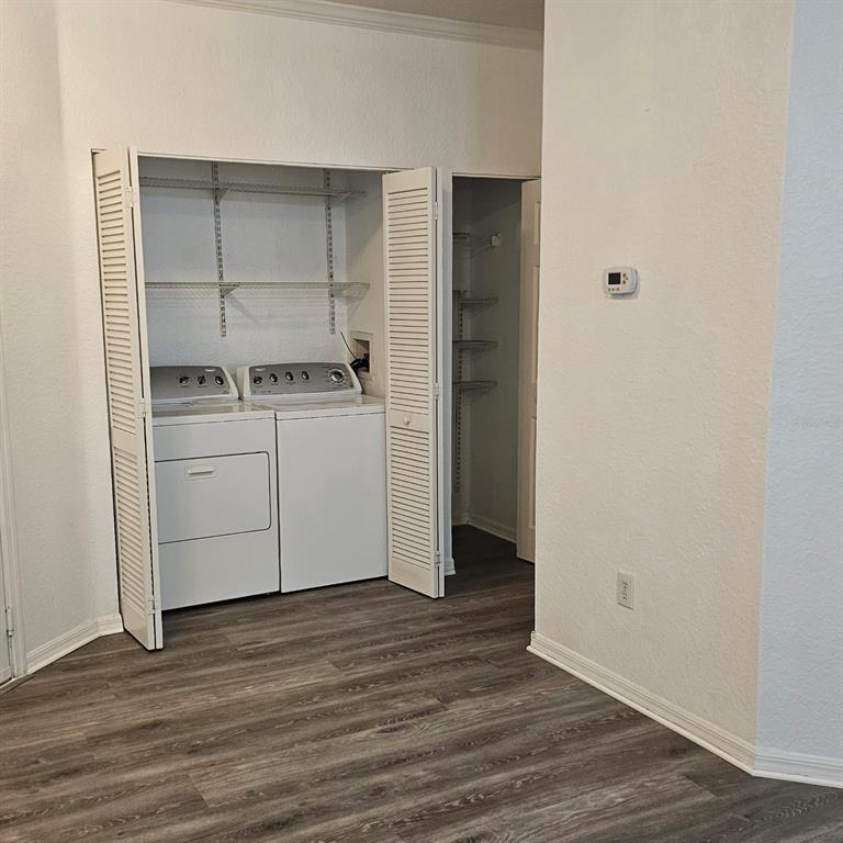 3599 Conroy Road, Unit 934 Orlando, FL 32839 - Photo 3 of 18 a kitchen with a stove and wooden floor