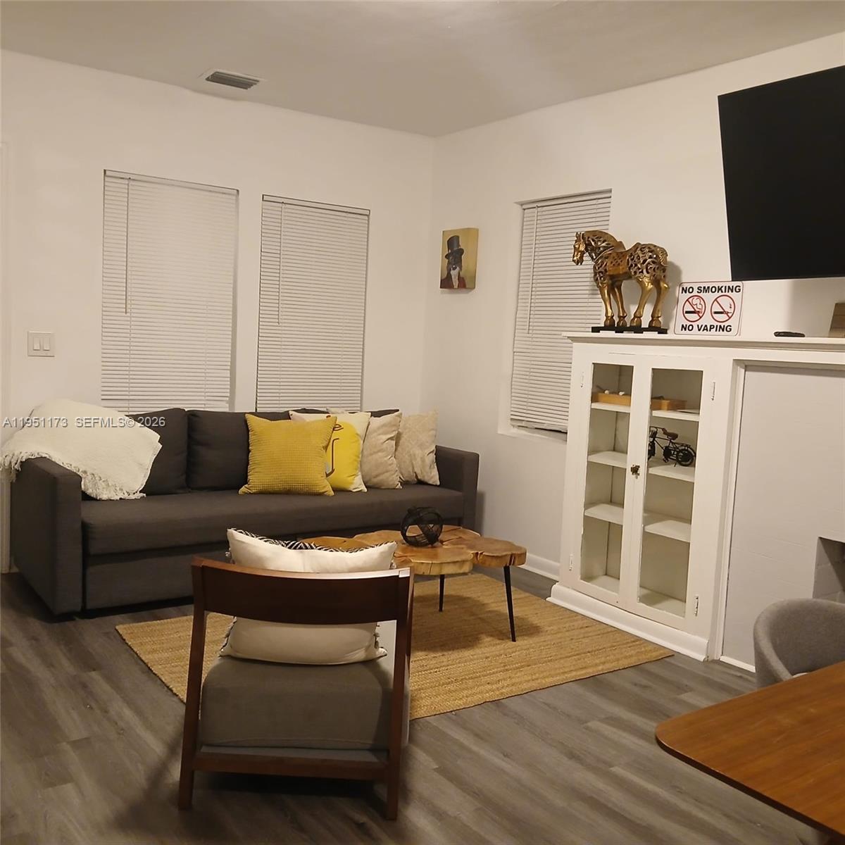 2993 Southwest 16th Terrace Miami, FL 33145 - Photo 4 of 17 a living room with furniture and a flat screen tv