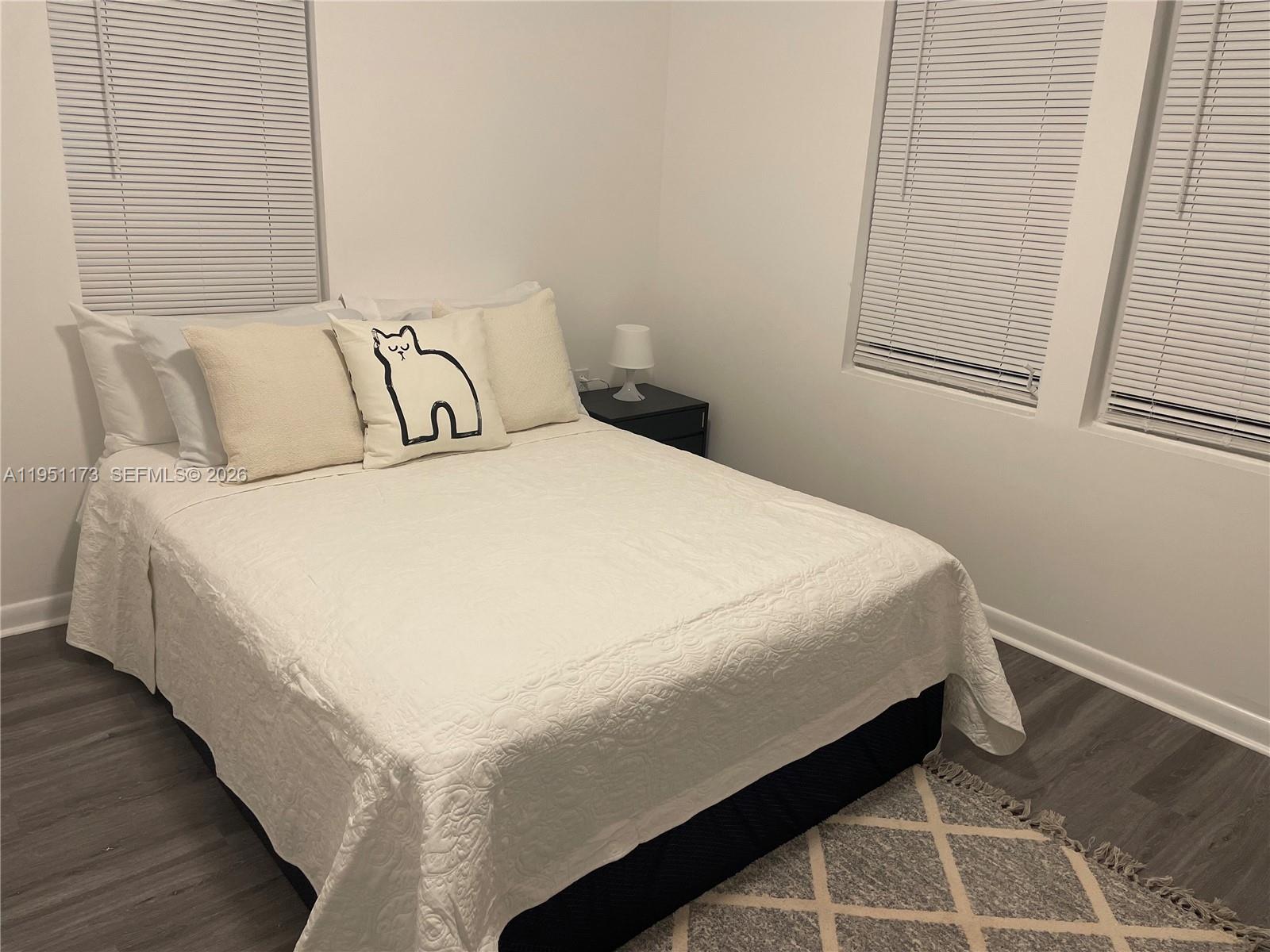 2993 Southwest 16th Terrace Miami, FL 33145 - Photo 5 of 17 a bed sitting in a bedroom next to a window