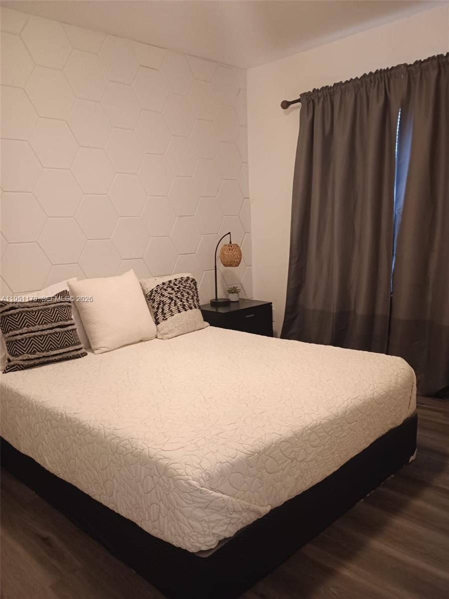 2993 Southwest 16th Terrace Miami, FL 33145 - Photo 7 of 17 a bedroom with a bed and wooden floor