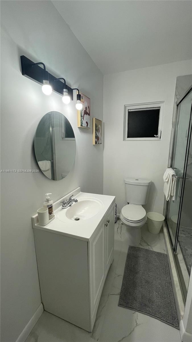 2993 Southwest 16th Terrace Miami, FL 33145 - Photo 8 of 17 a bathroom with a sink mirror and toilet