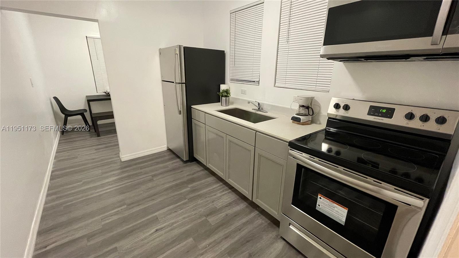 2993 Southwest 16th Terrace Miami, FL 33145 - Photo 9 of 17 a kitchen with a stove and a microwave