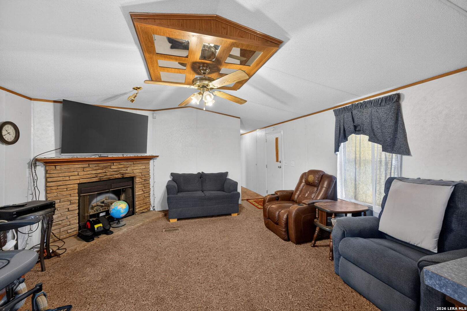 23398 Mathis Road Elmendorf, TX 78112 - Photo 5 of 18 a living room with furniture and a fireplace