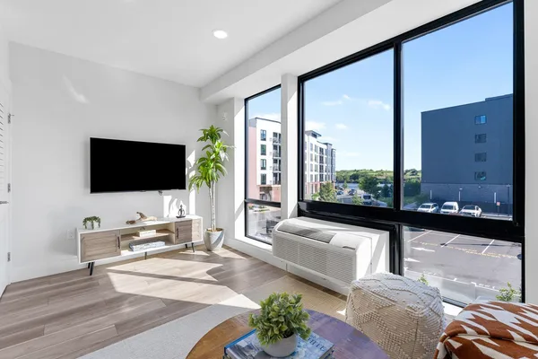 a living room with couches and a flat screen tv