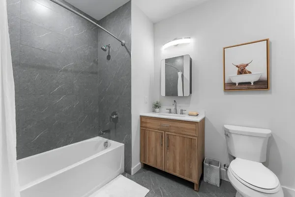 a bathroom with a toilet a sink and bathtub