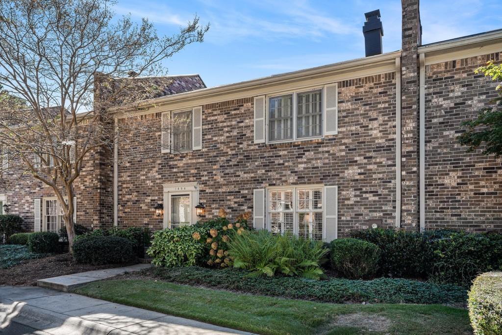 a view of a brick building next to a yard