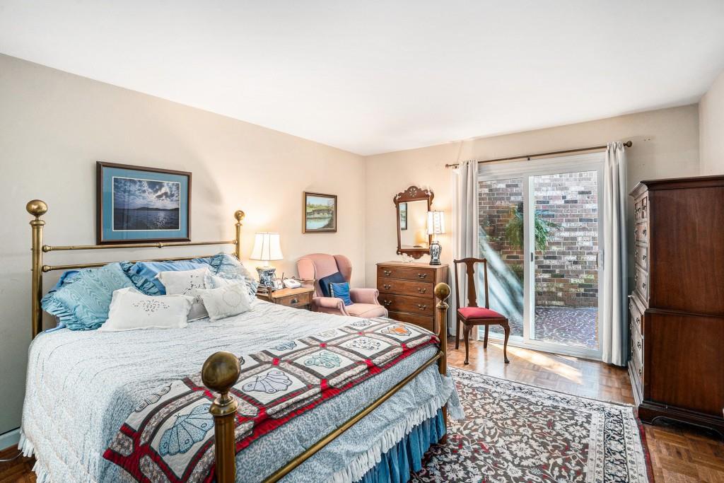 1484 Leafmore Place Decatur, GA 30033 - Photo 16 of 33 a bedroom with a bed a dresser and a large mirror with a bookshelf