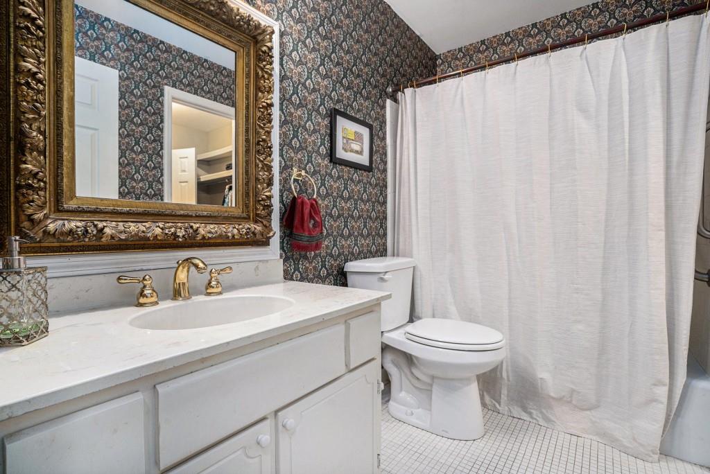 1484 Leafmore Place Decatur, GA 30033 - Photo 17 of 33 a bathroom with a sink a toilet and a mirror