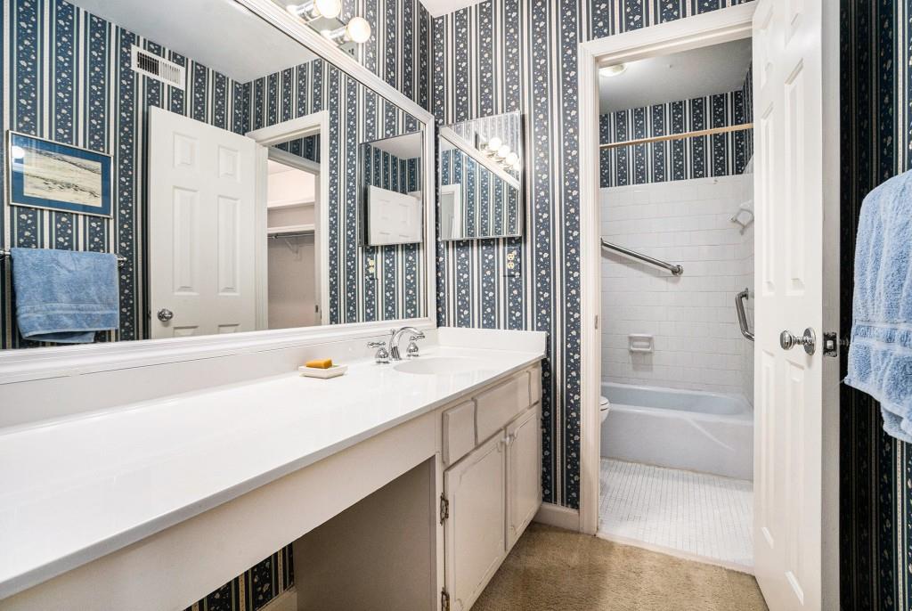 1484 Leafmore Place Decatur, GA 30033 - Photo 23 of 33 a bathroom with a double vanity sink a mirror and a bathtub