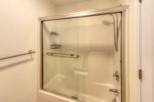 a bathroom with a glass shower door