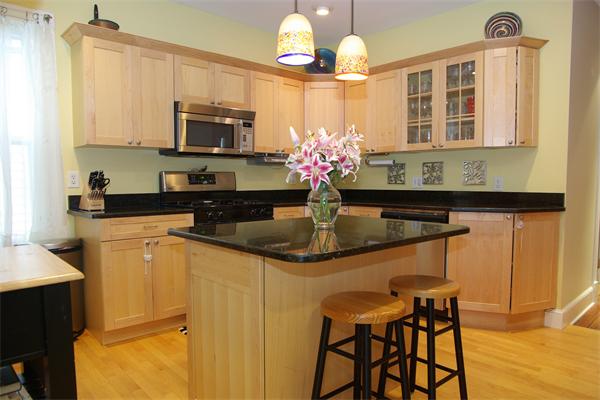 a kitchen with stainless steel appliances granite countertop a sink and cabinets