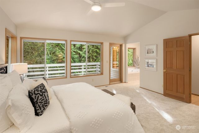 a bedroom with a large bed and a large window
