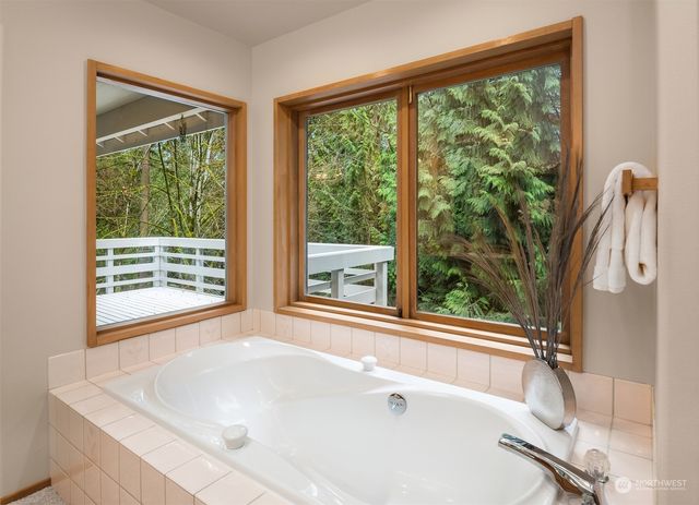 a white bath tub sitting in front of a window
