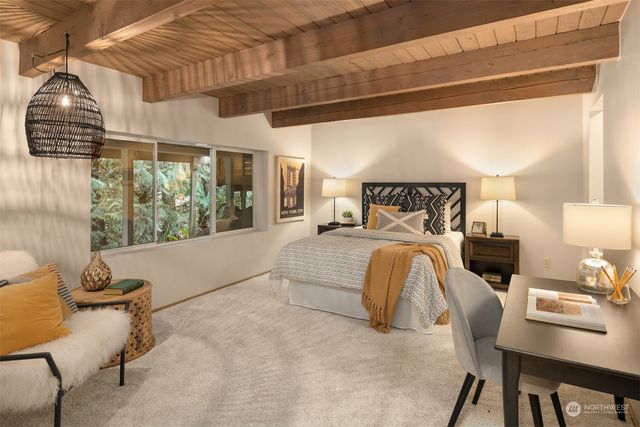 a bed room with a bed and a chair