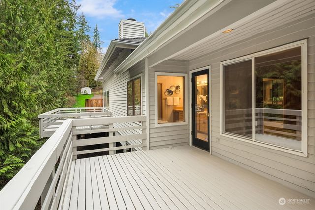 a balcony with a couch and wooden floor