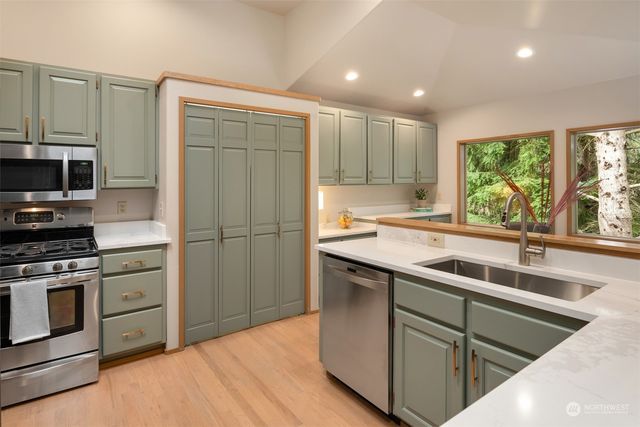 a kitchen with a sink stove and refrigerator