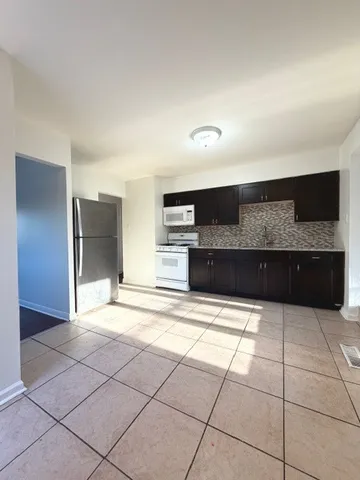 a kitchen with stainless steel appliances a sink and a cabinets