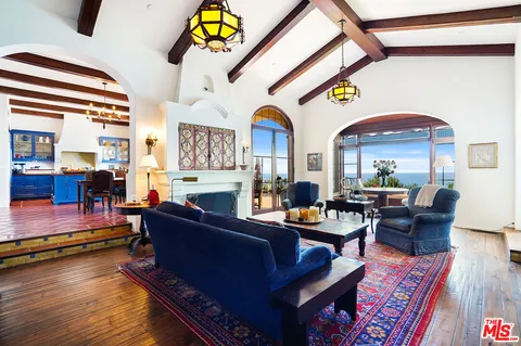 a living room with fireplace furniture and a wooden floor