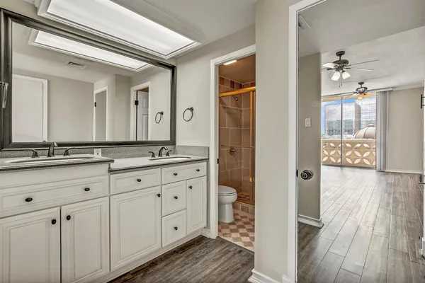a bathroom with a granite countertop sink mirror and