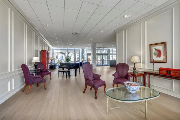 a dining room with furniture a rug and wooden floor